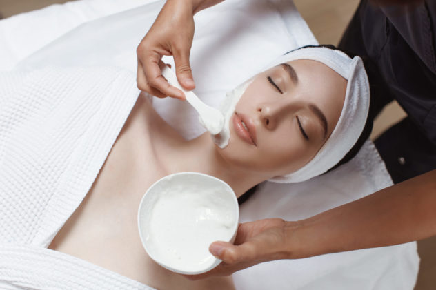 woman applying cosmetic alginate mask scaled